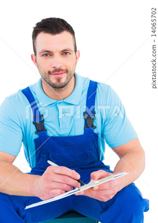 Plumber writing on clipboard while sitting on toolbox Plumber writing on clipboard while sitting on toolbox 14065702