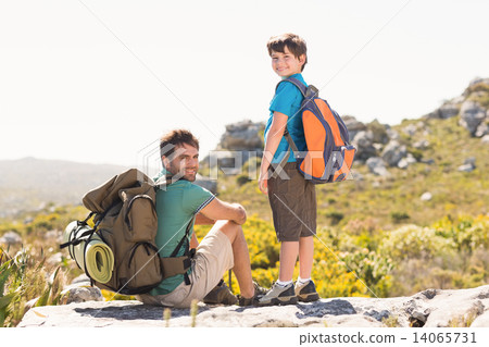 Father and son hiking through mountains 14065731