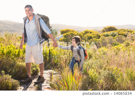 Father and son hiking through mountains 14065834