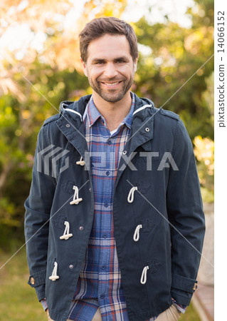 Handsome man smiling in his garden 14066152