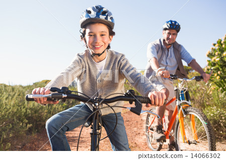 Father and son on a bike ride Father and son on a bike ride 14066302