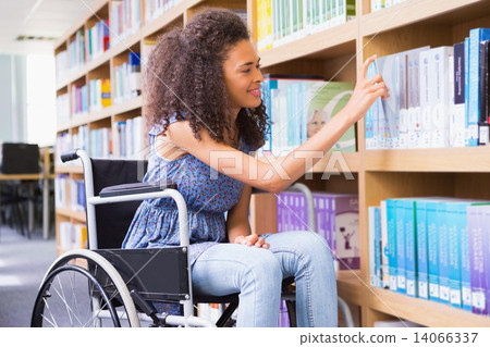 Smiling disabled student in library picking book Smiling disabled student in library picking book 14066337