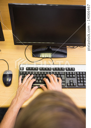 Student working on computer in classroom 14066467