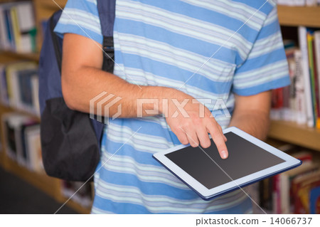 Student using tablet in library Student using tablet in library 14066737