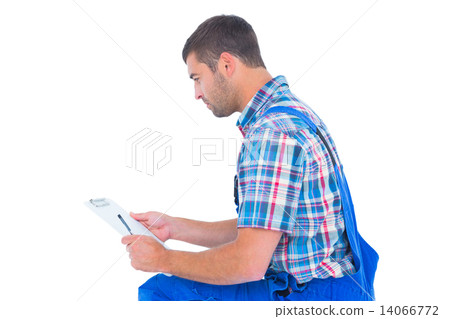 Handyman reading clipboard on white background 14066772