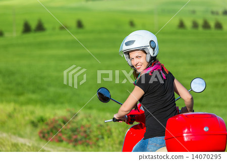 Young woman traveling by a scooter 14070295