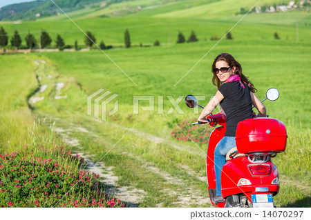 Young woman traveling by a scooter 14070297