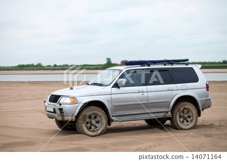 4x4 SUV on a sandy bank of a river 14071164