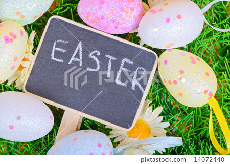 Easter eggs with chalkboard on the grass Easter eggs with chalkboard on the grass 14072440