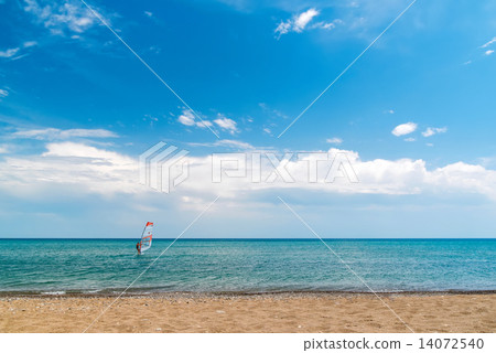A quiet sea, blue sky, a surfer on the horizon, beach 14072540
