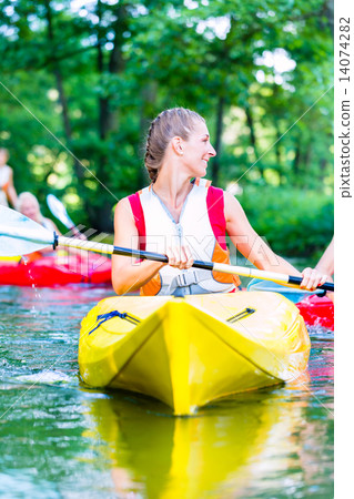 Woman paddling with canoe on forest river Woman paddling with canoe on forest river 14074282