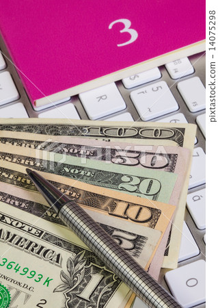 Business desk - Diary for March,US dollars,pen and keyboard Business desk - Diary for March,US dollars,pen and keyboard 14075298