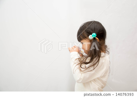 A girl drinking water with a cup A girl drinking water with a cup 14076393