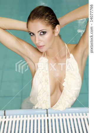 beautiful young woman standing in a swimming pool beautiful young woman standing in a swimming pool 14077766