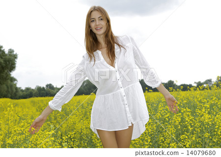brunette woman in a yellow flowers field brunette woman in a yellow flowers field 14079680