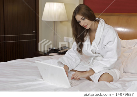 Portrait of beautiful woman with laptop on bed Portrait of beautiful woman with laptop on bed 14079687