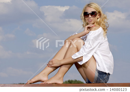 beautiful girl in sunglasses on background blue sky 14080123