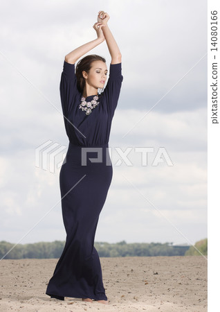 Sexy brunette posing in violet dress. 14080166