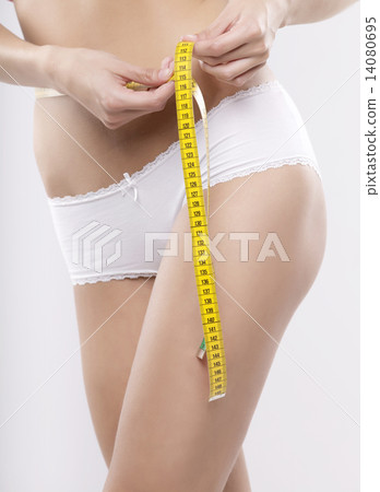 Beautiful sporty woman with yellow measure around body Beautiful sporty woman with yellow measure around body 14080695