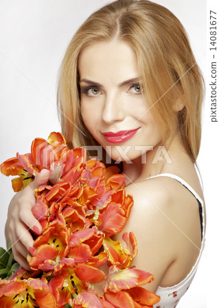 Beautiful blonde girl with the bouquet of tulips isolated on a w 14081677