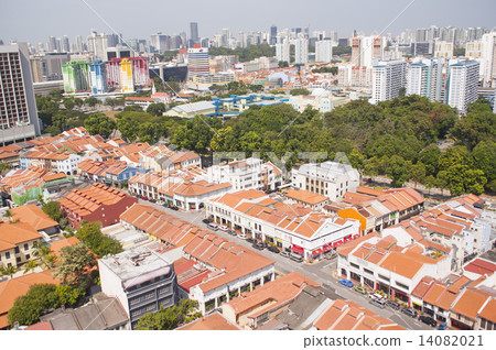 Singapore skyline and colonial shophouses with orange clay roof tiles. 14082021