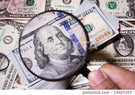 magnifying glass lies on american dollars magnifying glass lies on american dollars 14085265
