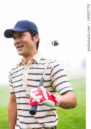 Smiling golfer standing and holding his club Smiling golfer standing and holding his club 14085778