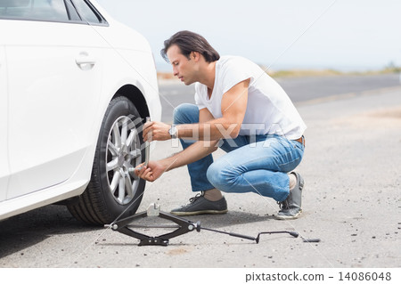 Man changing wheel after a car breakdown Man changing wheel after a car breakdown 14086048