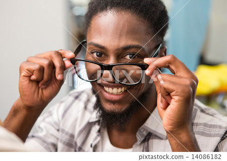 Happy male fashion designer holding eye glasses Happy male fashion designer holding eye glasses 14086182