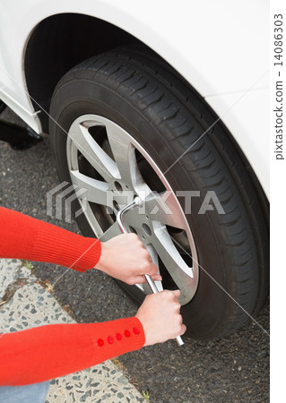 Woman replacing tire 14086303