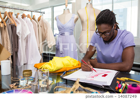 Attractive male fashion designer sketching Attractive male fashion designer sketching 14087249