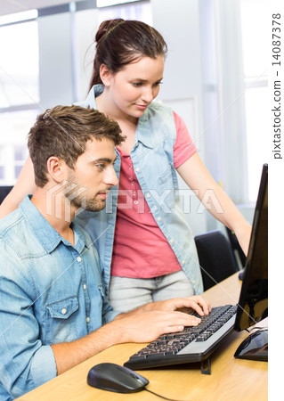 Computer teacher helping pretty female student Computer teacher helping pretty female student 14087378