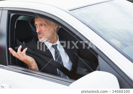 Perplexed businessman in the drivers seat 14088100