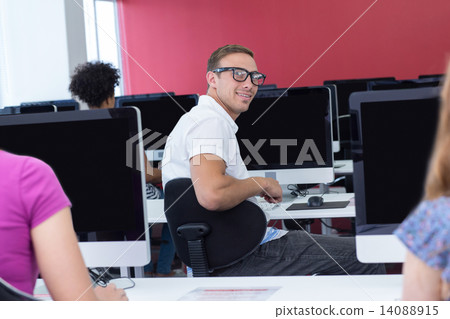 Student smiling at camera in computer class Student smiling at camera in computer class 14088915