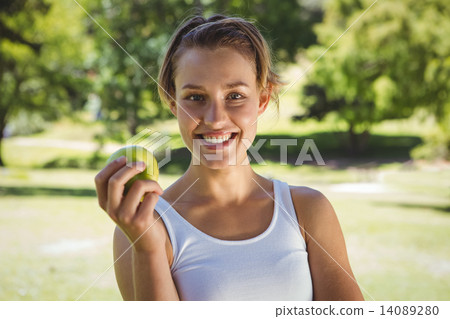 Fit woman holding green apple 14089280