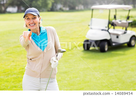 Female golfer smiling at camera Female golfer smiling at camera 14089454