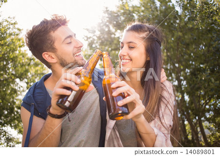 Happy friends in the park having beers Happy friends in the park having beers 14089801