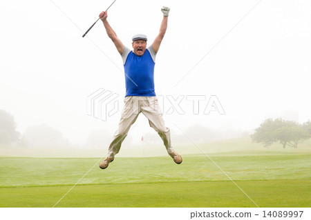 Excited golfer jumping up and smiling at camera Excited golfer jumping up and smiling at camera 14089997