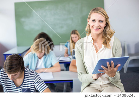 Stock Photo: Female teacher using digital tablet in class