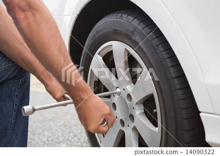 Man fixing tire Man fixing tire 14090322