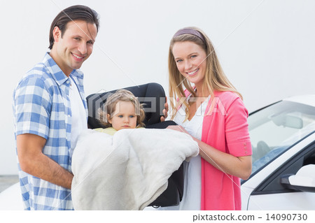 Parents carrying baby in his car seat Parents carrying baby in his car seat 14090730