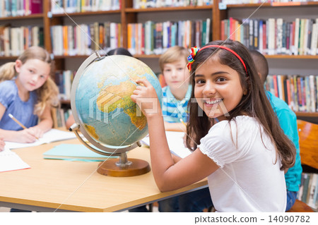 Cute pupils looking at globe in library Cute pupils looking at globe in library 14090782