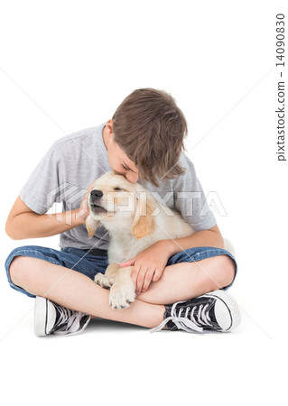 Boy kissing puppy over white background Boy kissing puppy over white background 14090830