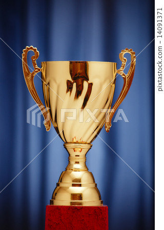 Stock Photo: Gold Cup on a dark blue background