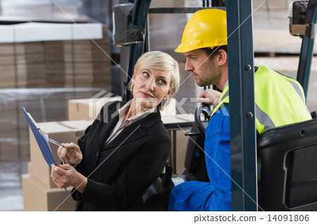 Warehouse manager talking with forklift driver 14091806
