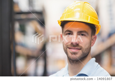 Close up of worker wearing hard hat in warehouse Close up of worker wearing hard hat in warehouse 14091807