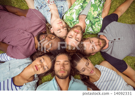 Happy young friends lying on grass 14092331