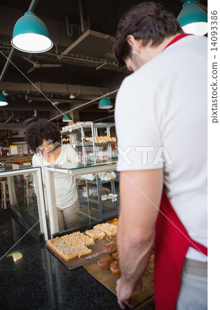 Smiling customer standing and choosing food 14093386