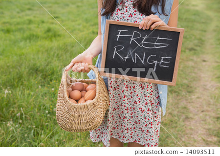 Woman holding basket of free range eggs Woman holding basket of free range eggs 14093511