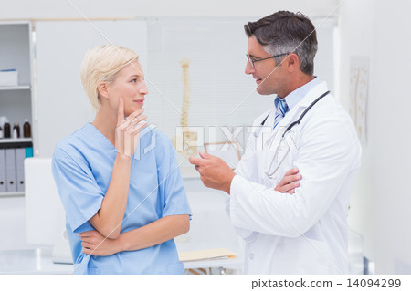 Doctor and nurse discussing in clinic 14094299